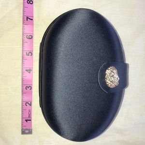 Oval shaped satin navy blue hard case clutch